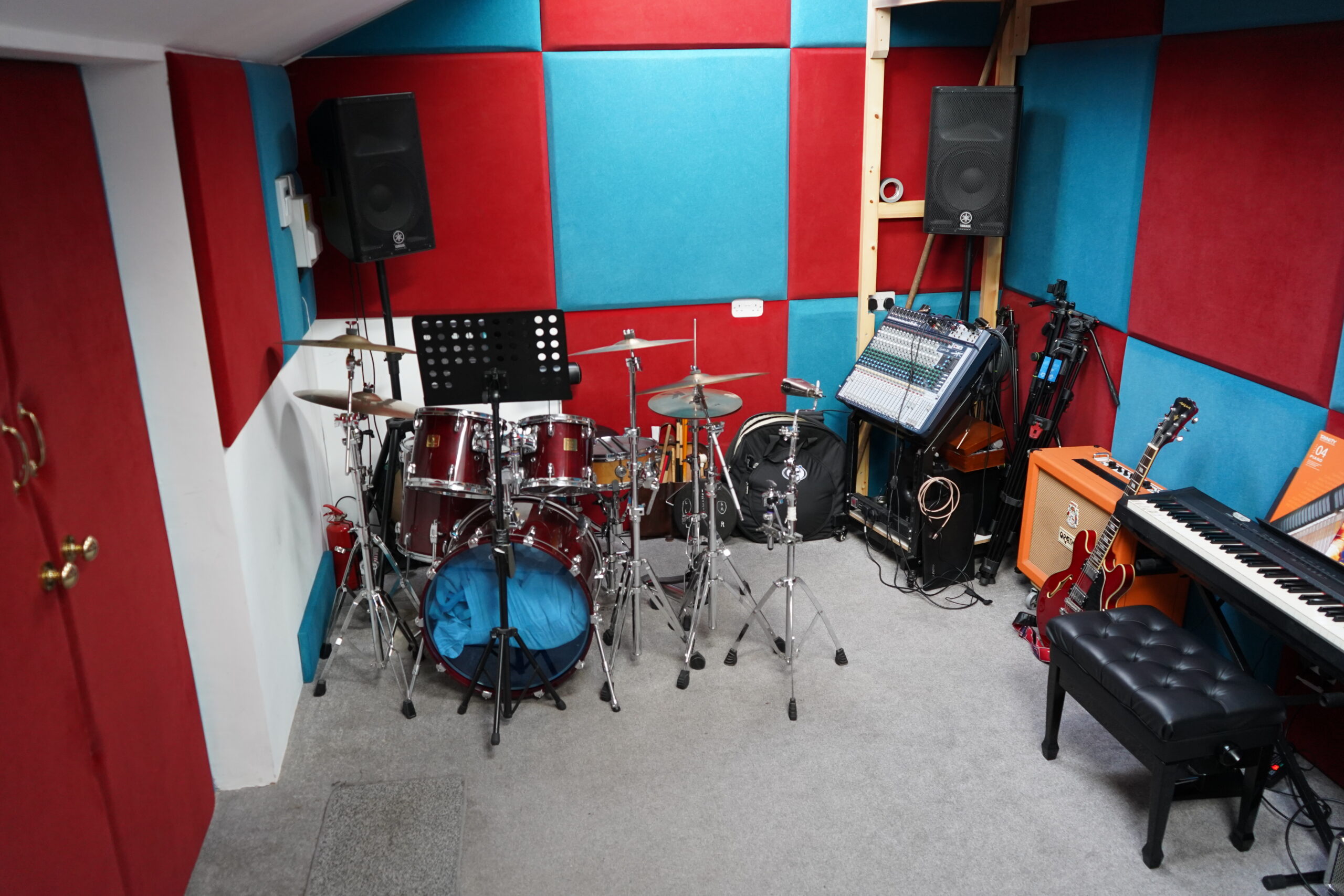 Drum kit, PA speakers and mixing desk in the rehearsal room at Harrow Music Studio
